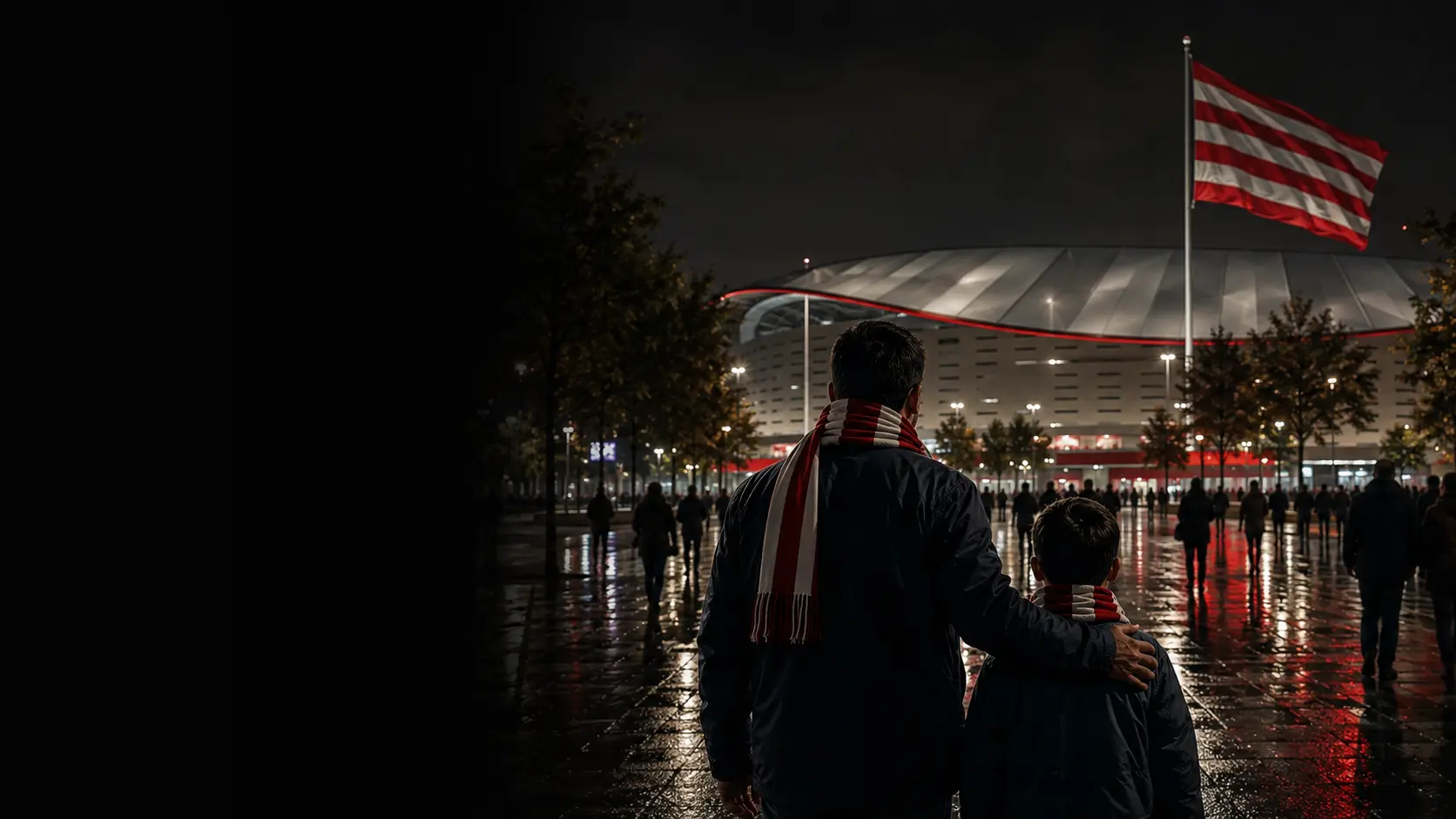 Un adulto y un niño caminan hacia un estadio rojiblanco en Madrid junto a una bandera de franjas rojas y blancas
